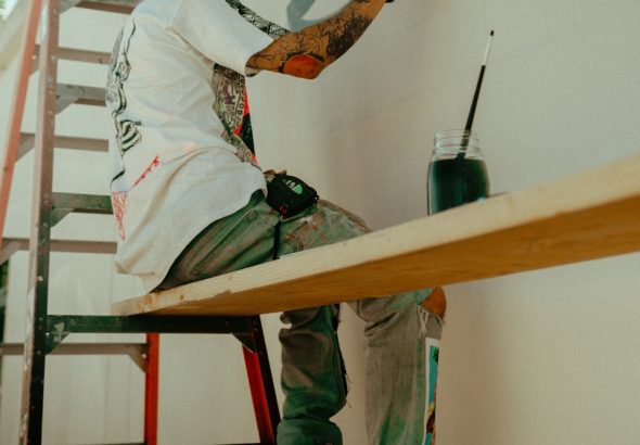 man in white long sleeve shirt sitting on brown wooden table